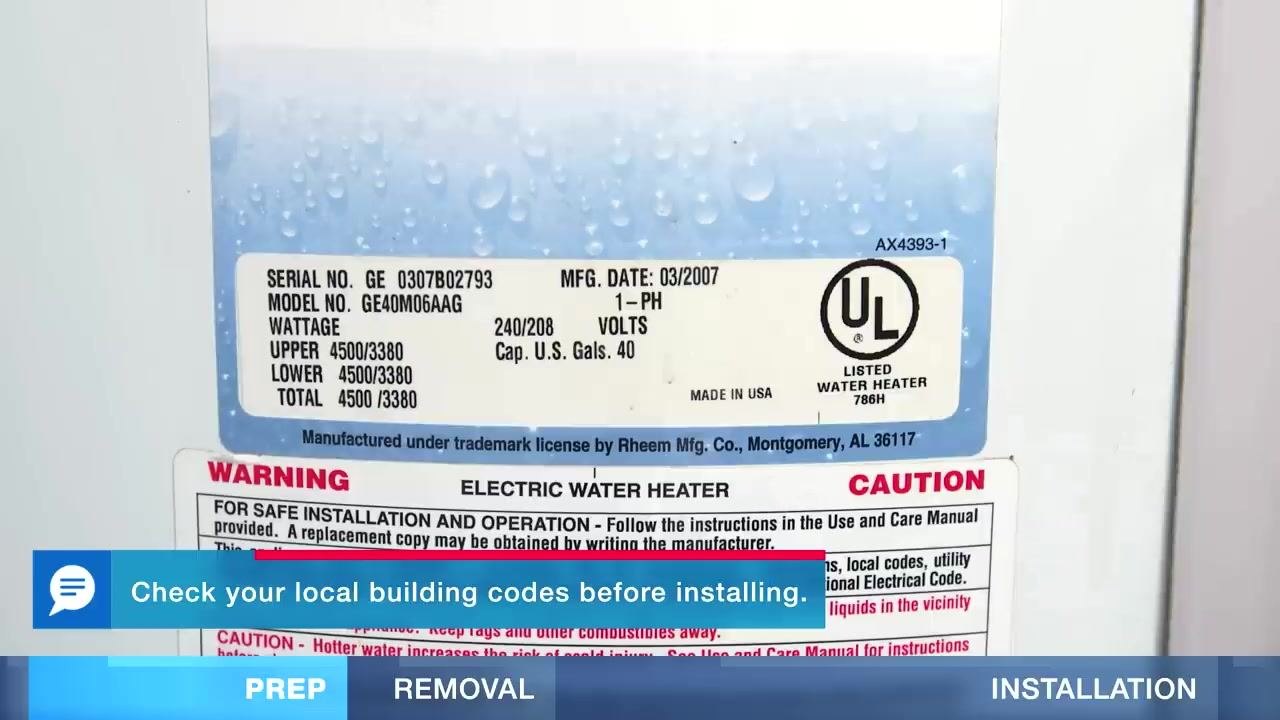 A water heater with a visible puddle of water on the floor, a warning label, and a tool bag nearby.