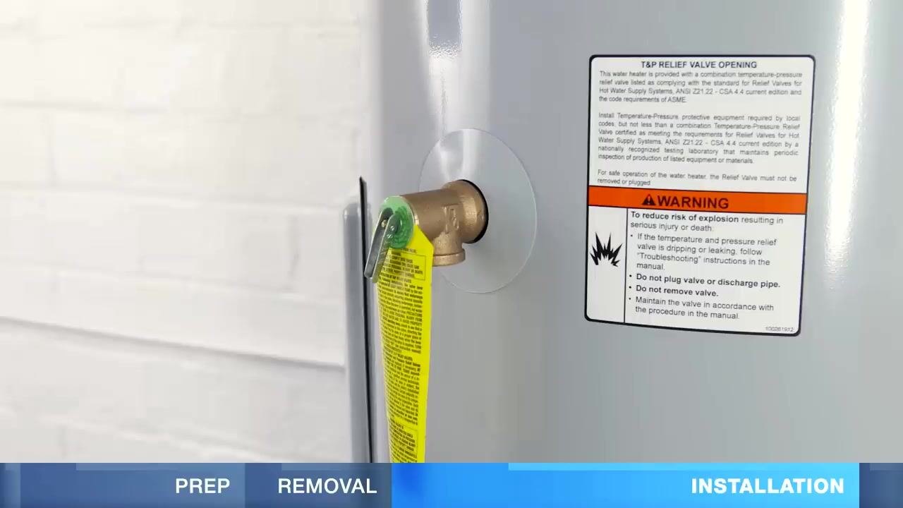 Close-up of a new water heater with a T&P relief valve installed and a warning label about explosion risk.