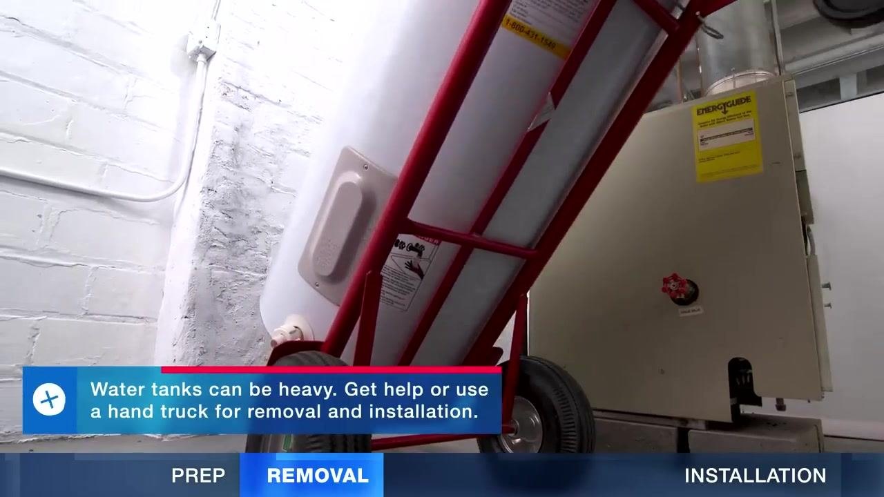 A person positioning a copper discharge pipe into a bucket under the T&P relief valve of a new water heater.