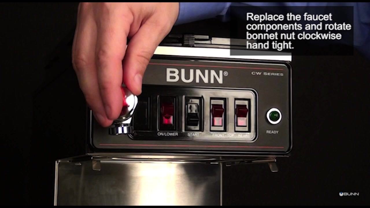 A hand reinstalls the faucet handle and bonnet nut onto the brewer, turning the nut clockwise.