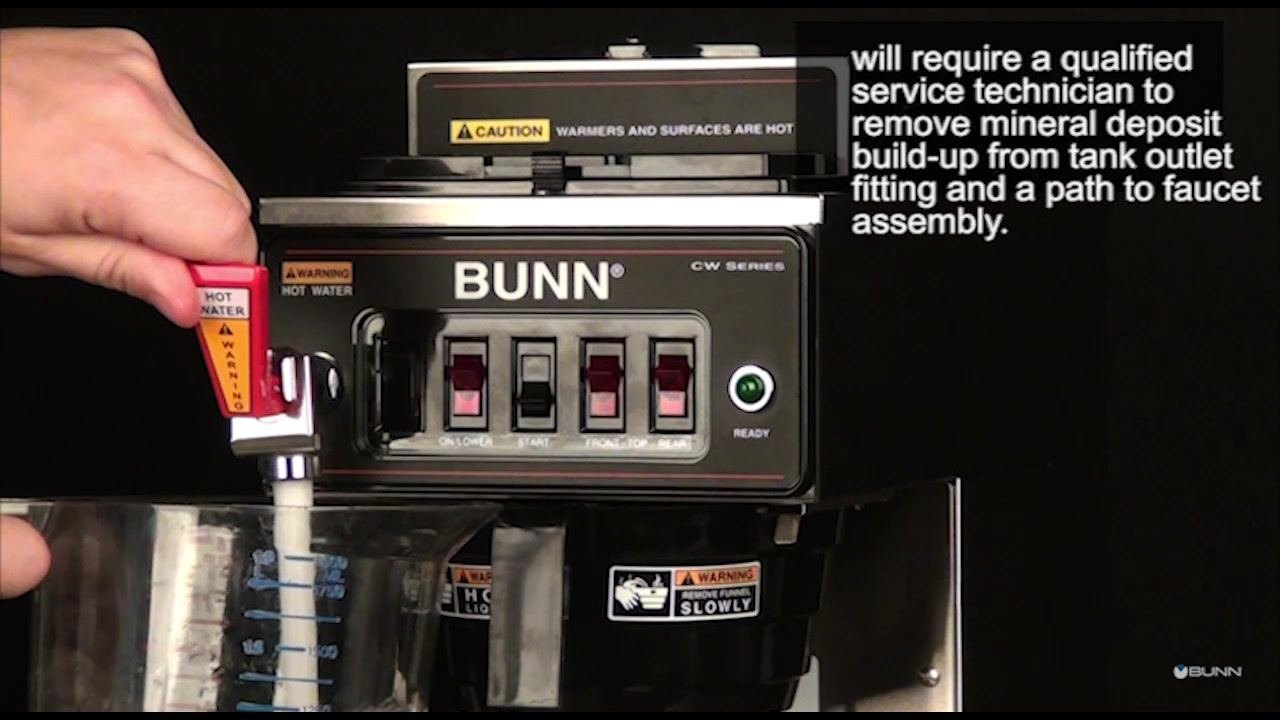 A hand wipes the exterior of the BUNN brewer with a white damp cloth.