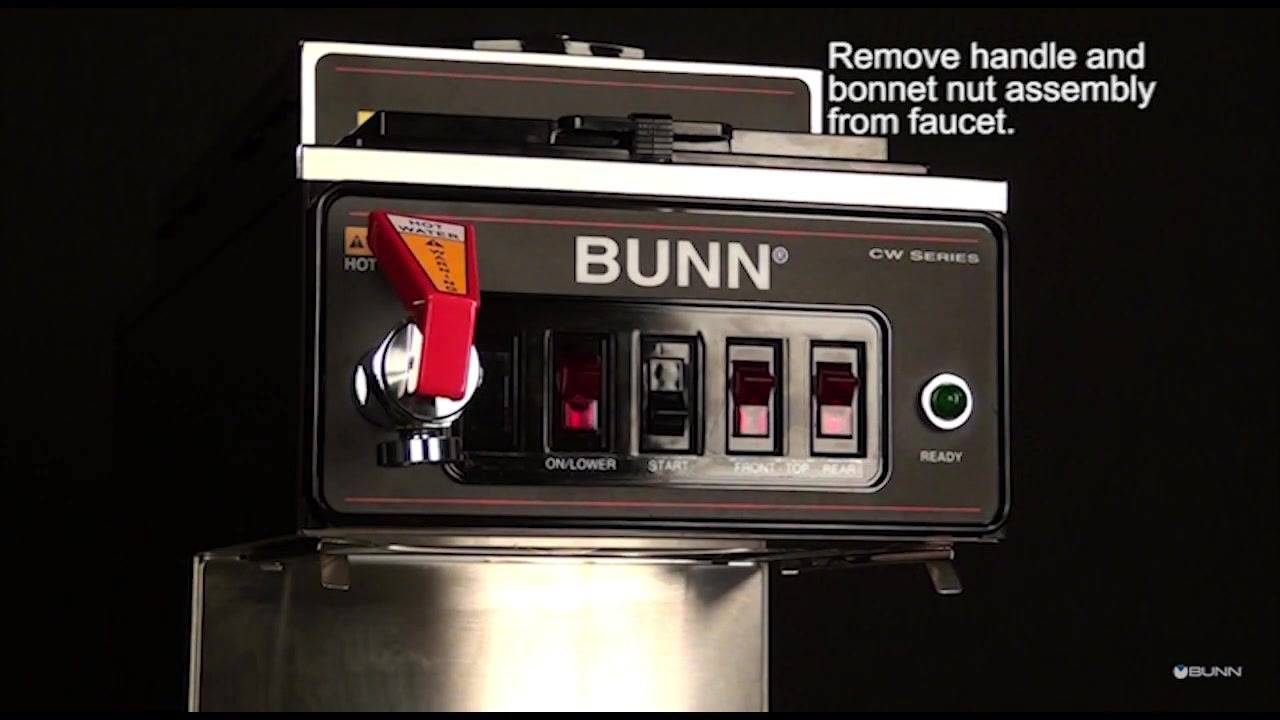 A front view of the BUNN CW Series coffee brewer shows the red faucet handle attached, ready for the handle and bonnet nut assembly to be removed.