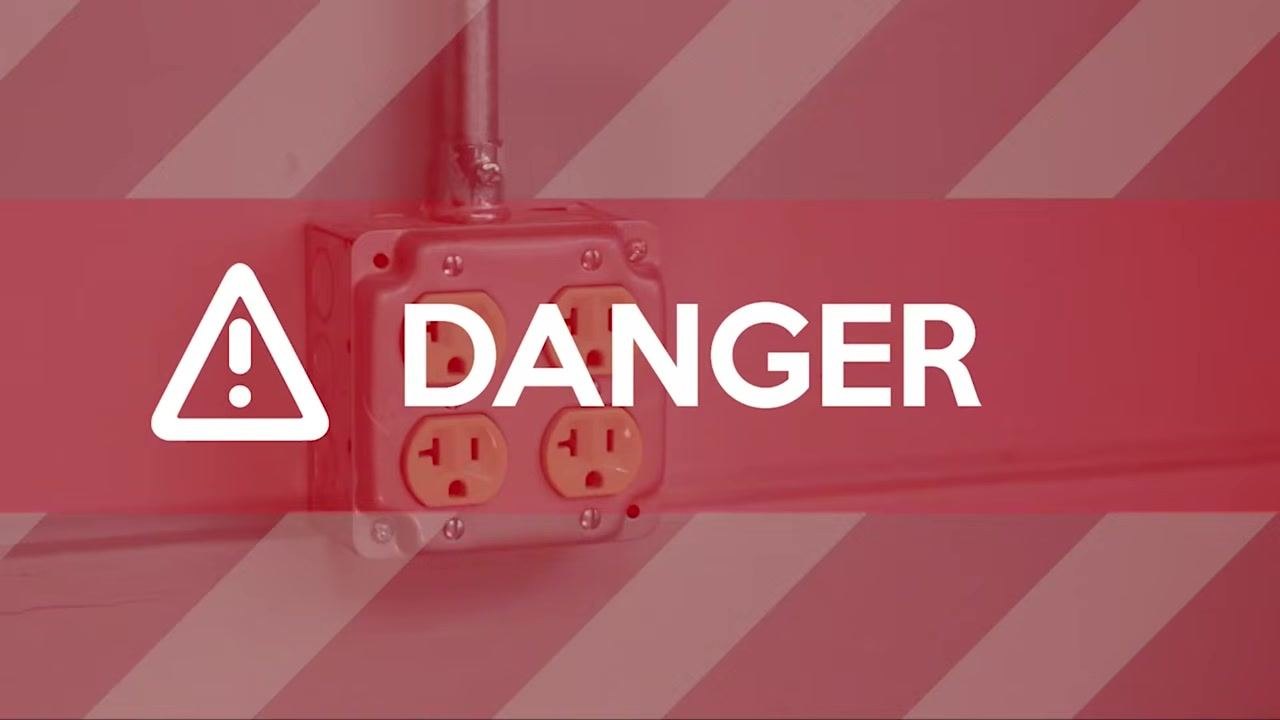 Red warning overlay reading "DANGER" with an exclamation mark, showing a wall power outlet.