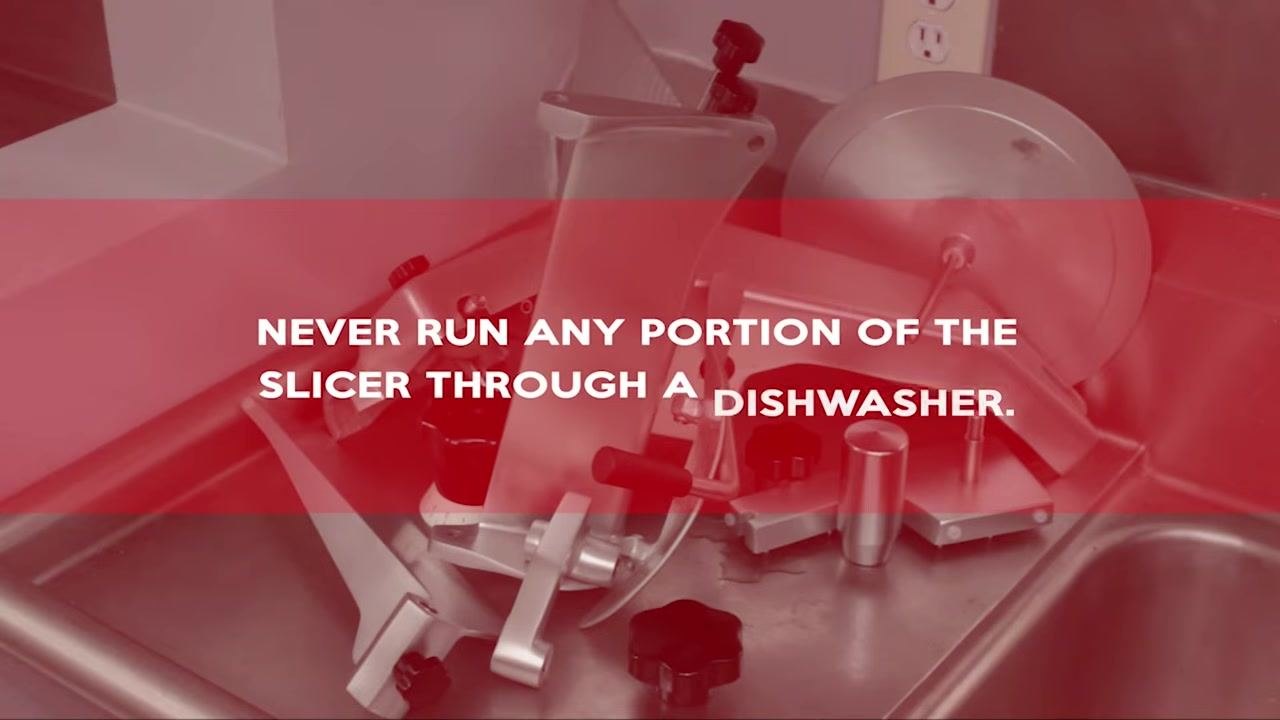 Red warning overlay reading "NEVER RUN ANY PORTION OF THE SLICER THROUGH A DISHWASHER," with slicer parts visible in a sink.