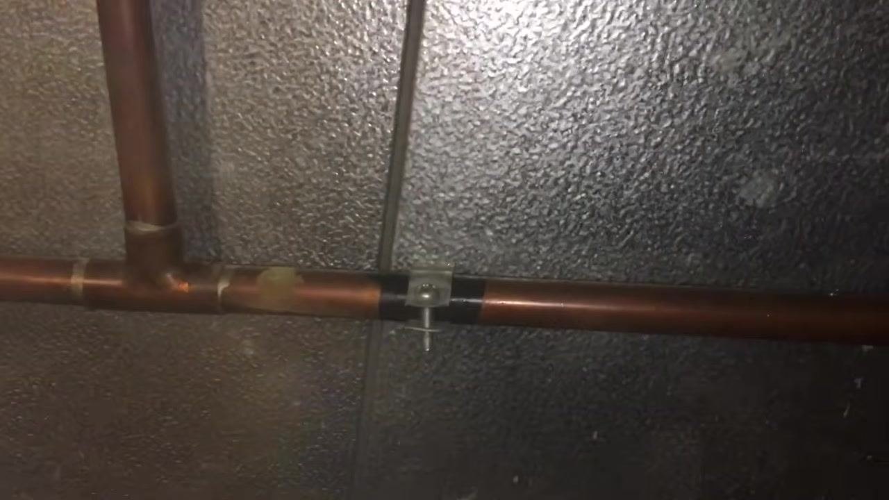 Another view of copper pipes and wall showing the workspace environment