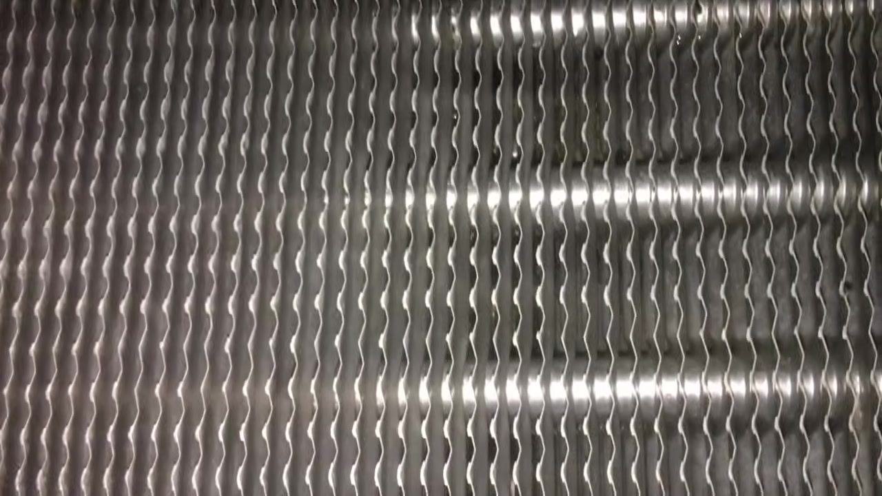 Close-up of clean, metallic heat exchanger tubes with no visible dirt or debris