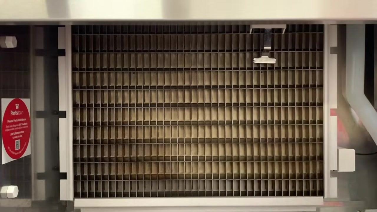 View of the evaporator grid inside the ice machine, shown empty and ready for inspection