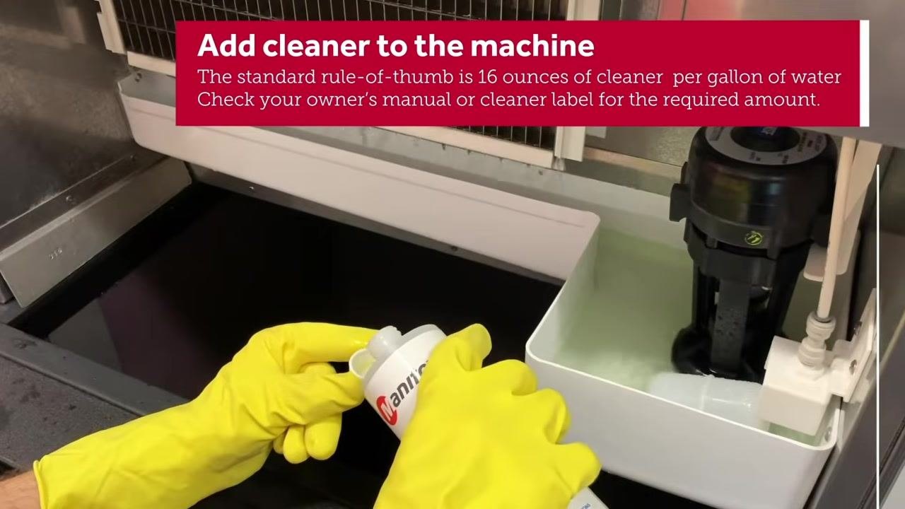 Person putting on yellow gloves and safety goggles at the counter, preparing to handle chemicals