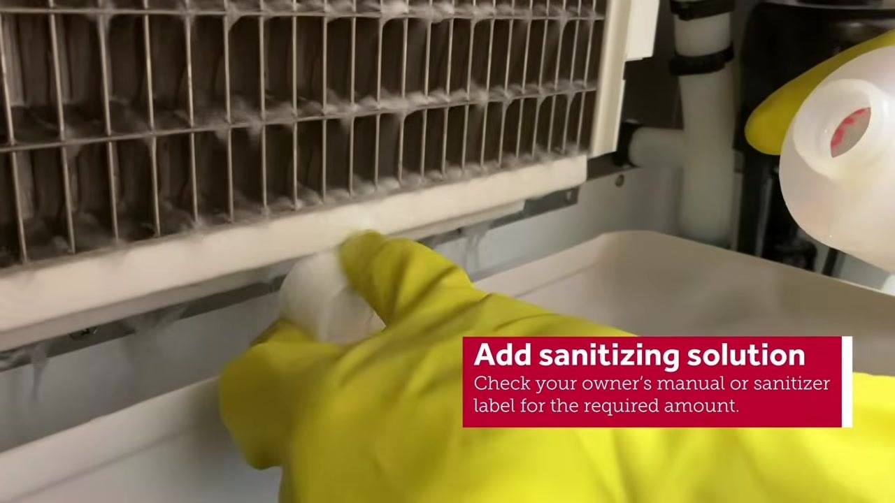 Sanitizing solution visible in the water trough, with the on-screen instruction "Add sanitizing solution. Check your owner's manual or sanitizer label for the required amount."