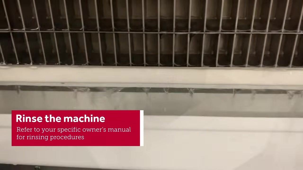 Close-up of the machine's internal components being rinsed with water, with the on-screen instruction "Rinse the machine. Refer to your specific owner's manual for rinsing procedures"