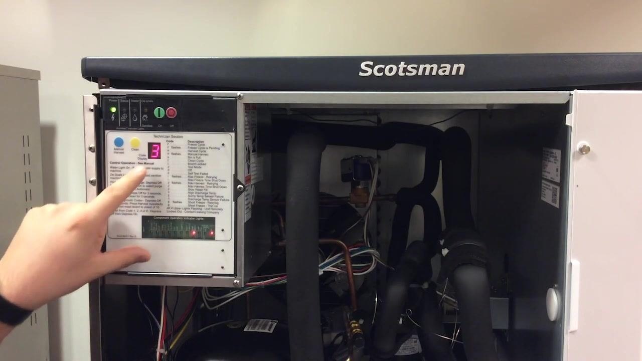 Control panel of the Scotsman ice machine showing code 3, blinking red status and water lights, and the technician section with codes and descriptions
