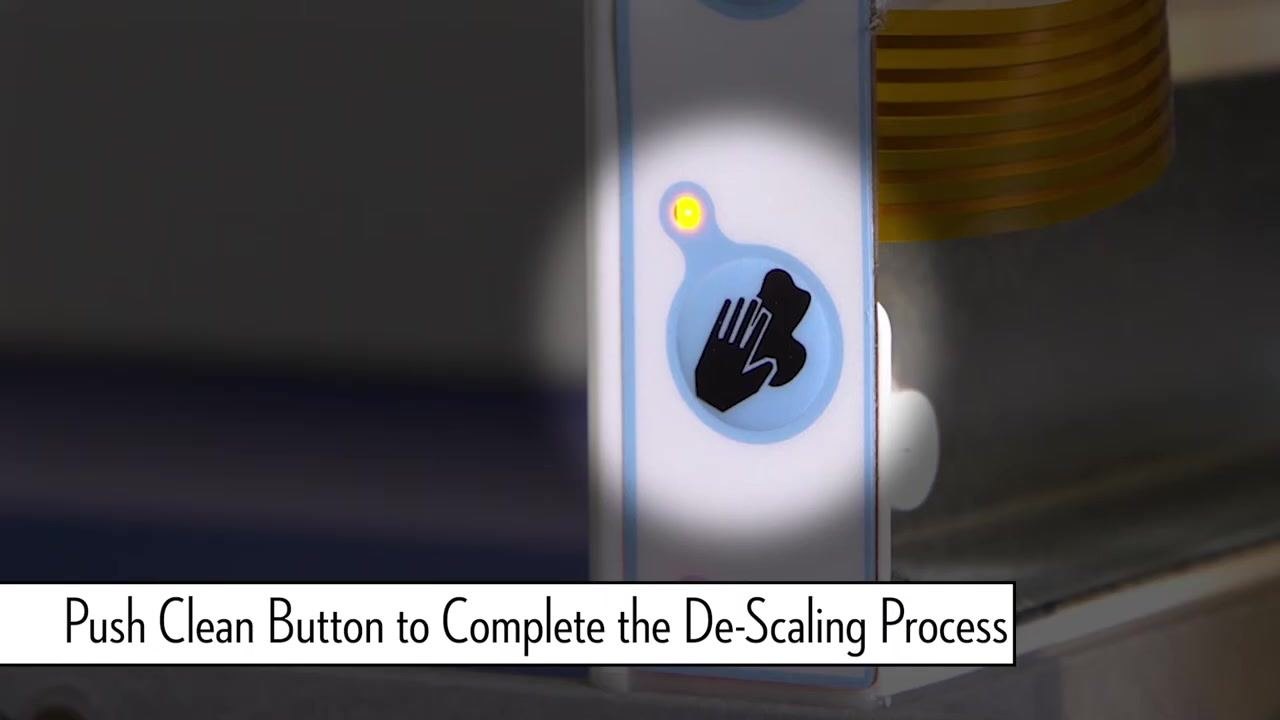 Close-up of the clean button with a yellow indicator light illuminated.