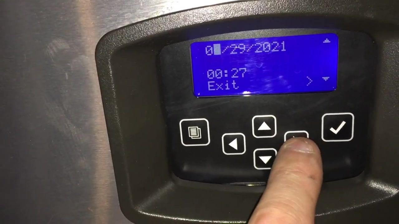 Display showing date "04/29/2021" and time "00:27," with finger pressing the right arrow to move between fields
