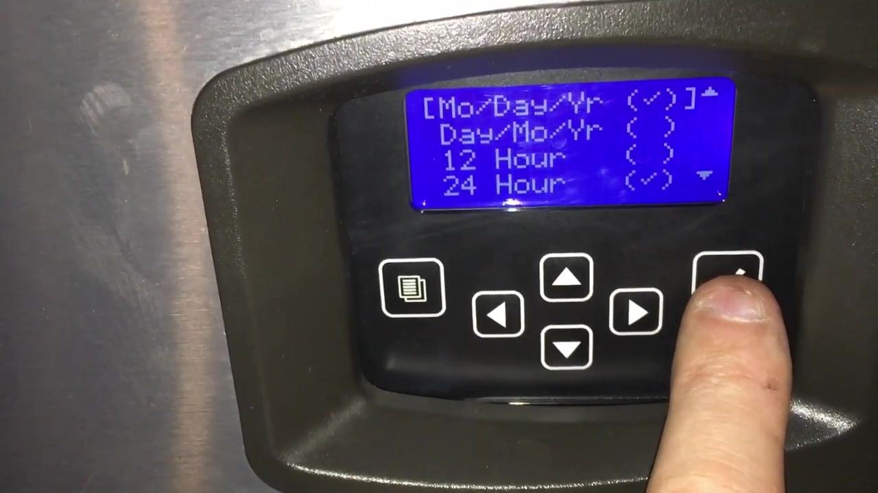 Screen with date and time format options, finger pressing the right arrow