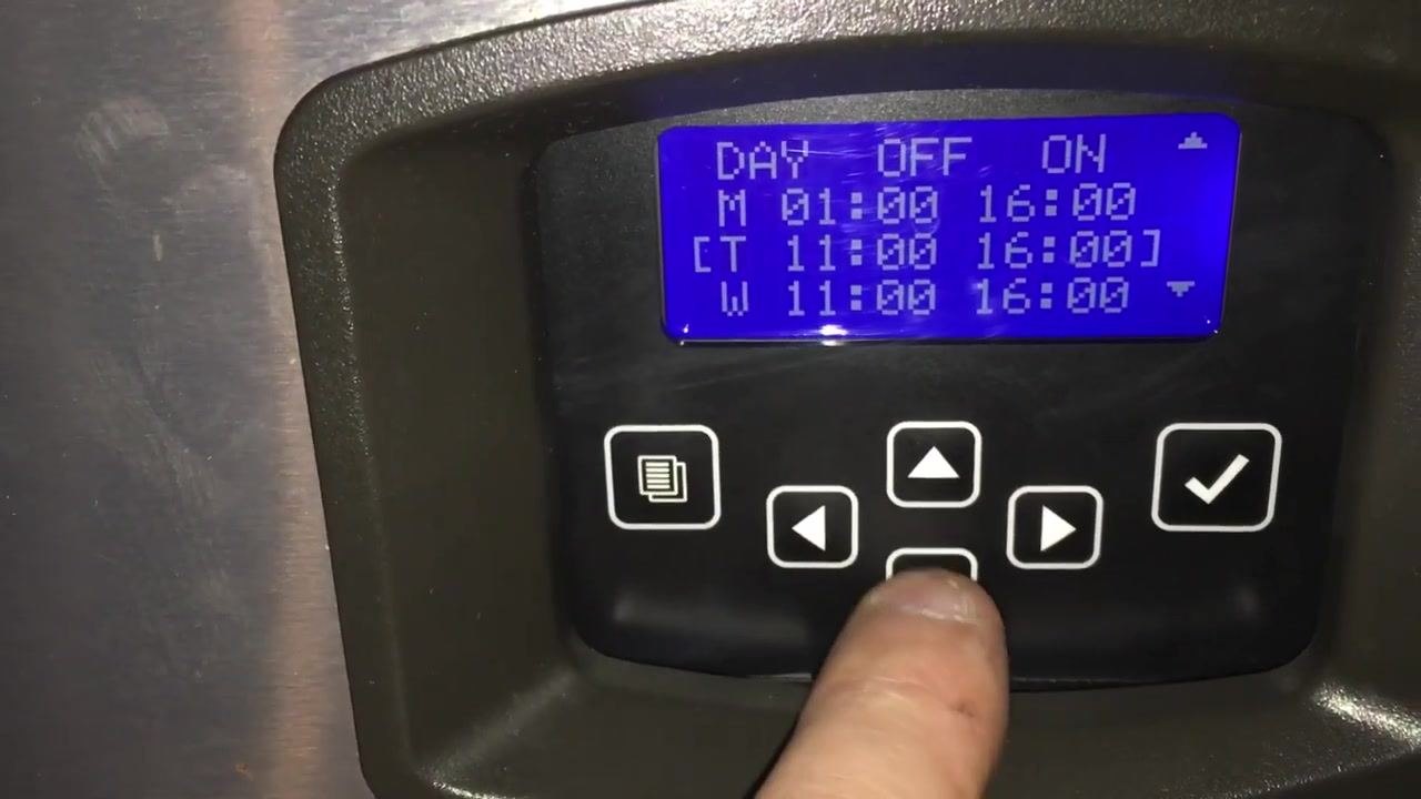 Schedule grid with Tuesday selected, finger pressing a navigation button