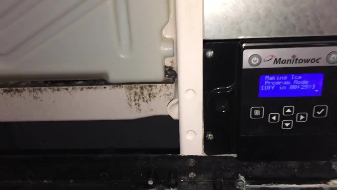 Internal mechanism above the bin, showing yellow wire, metal brackets, and plastic housing
