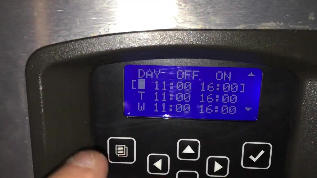 Finger pressing select, with "Time Prog (✓)" shown as enabled