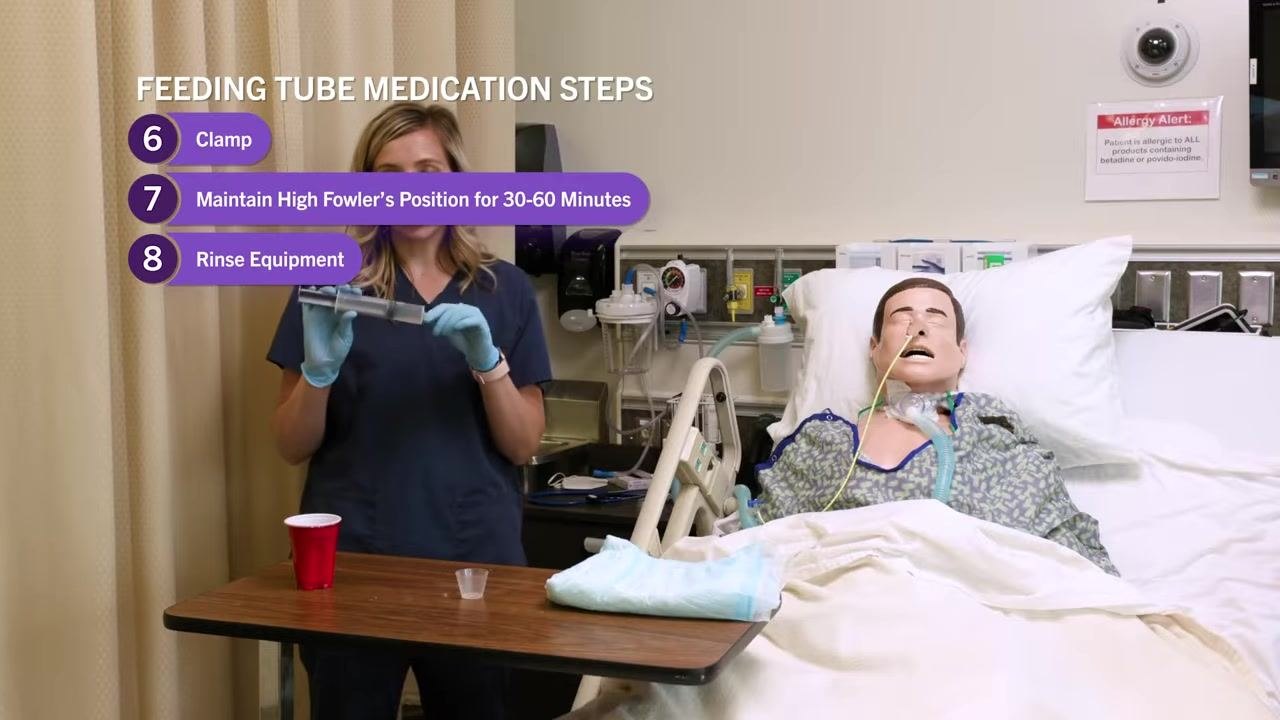 Nurse holding the syringe while demonstrating rinsing, with on-screen text highlighting step 8: "Rinse Equipment." Supplies on the table, mannequin in bed.