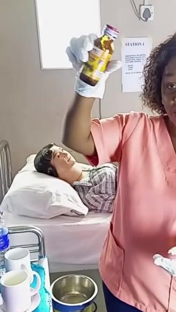 A healthcare worker demonstrating proper technique for opening a medication bottle, holding the cap and bottle separately.