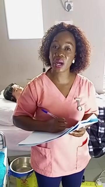 A healthcare worker continuing to document the medication administration in the patient's chart.