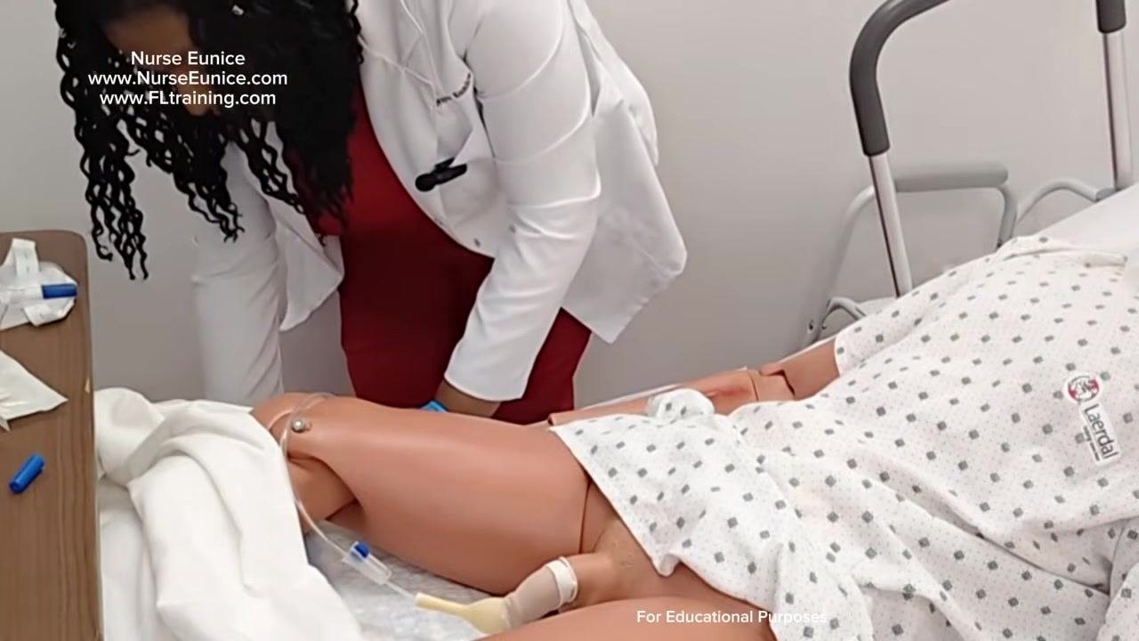 Nurse holding the drainage tubing and removing the protective cover, preparing to connect it to the catheter