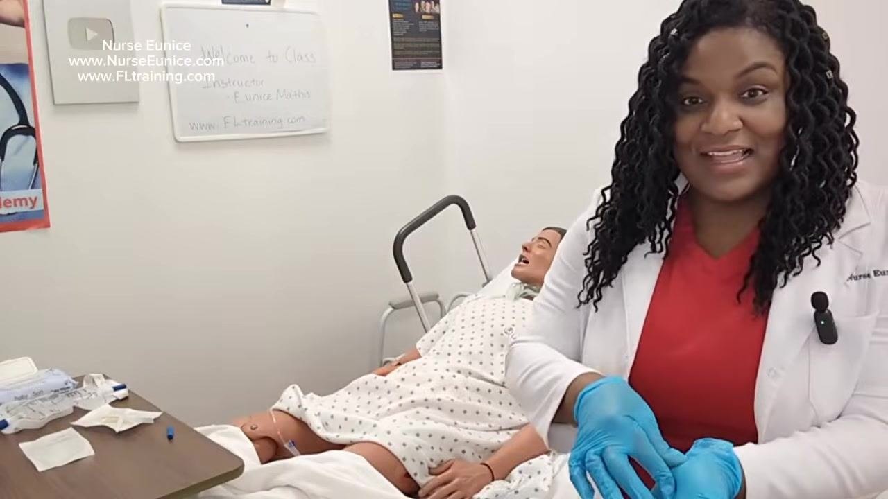 Nurse demonstrating hand hygiene and discussing cleanup and safety reminders, with the mannequin patient in bed
