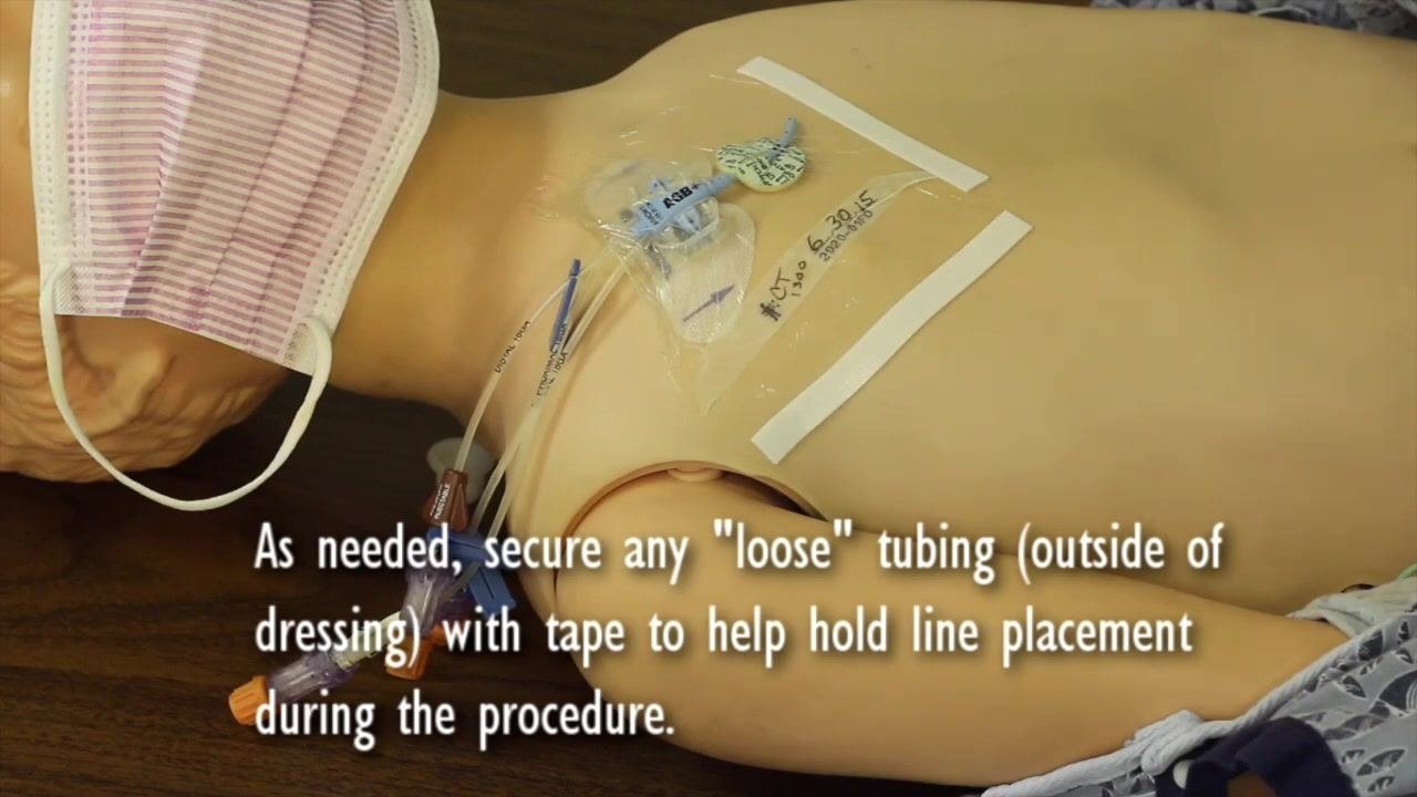 Nurse putting on gloves and placing a mask on herself, with on-screen guidance to mask both patient and nurse.