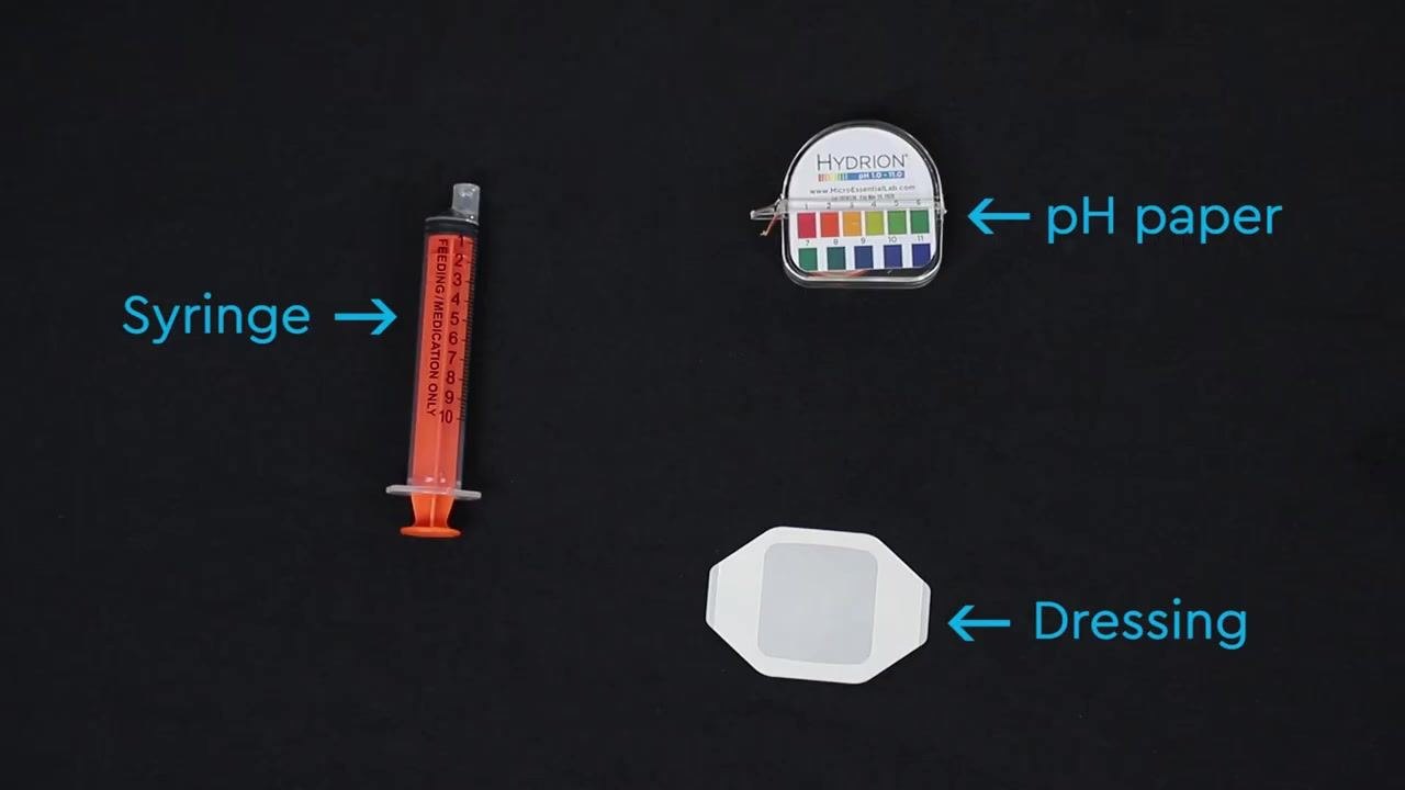 Person holding the syringe attached to the NG tube while pulling back to withdraw stomach contents