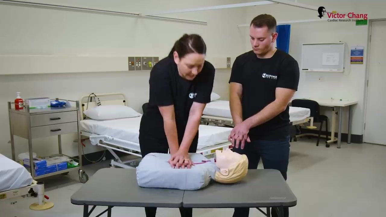 Coordinating a handover during CPR, with both rescuers' hands on the manikin's chest.