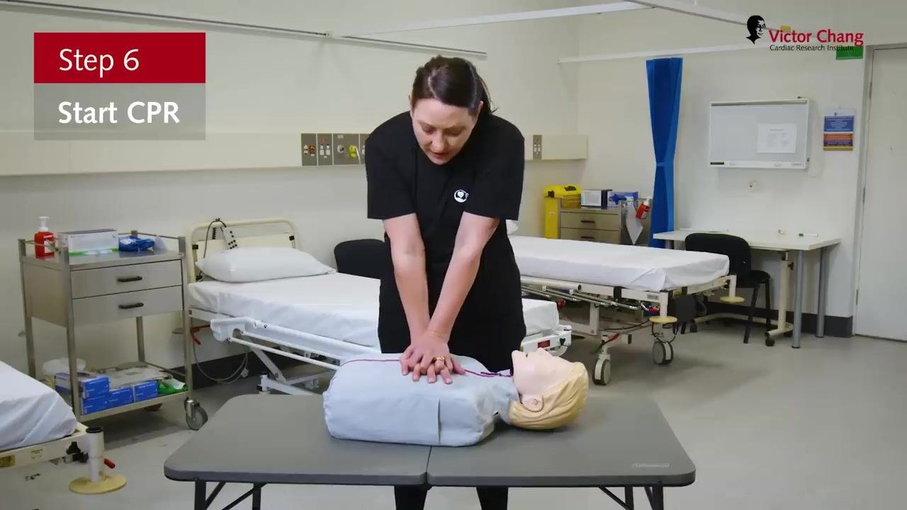 Performing chest compressions on a manikin with arms straight and hands interlocked, with on-screen text "Step 6: Start CPR."
