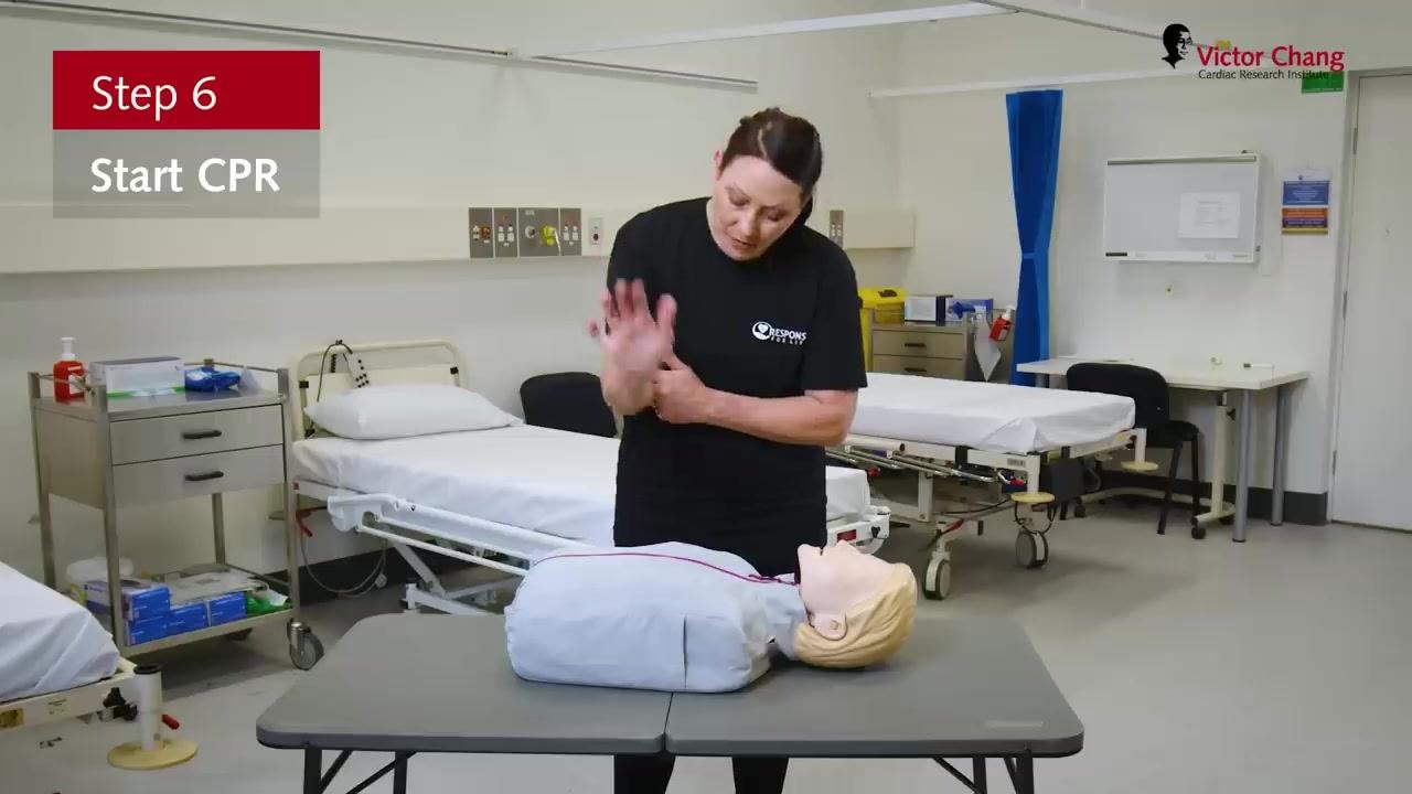 Correct hand positioning for chest compressions, hands interlocked above the manikin's chest, with on-screen text "Step 6: Start CPR."