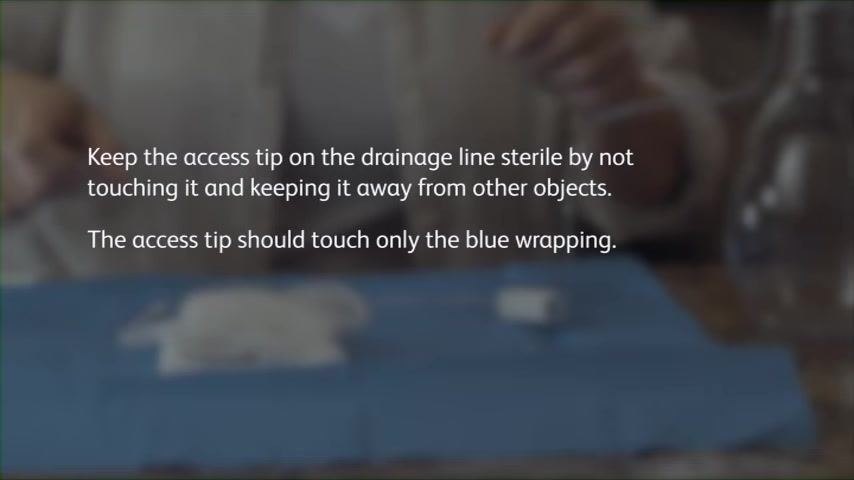Text overlay: "Keep the access tip on the drainage line sterile by not touching it and keeping it away from other objects. The access tip should touch only the blue wrapping."