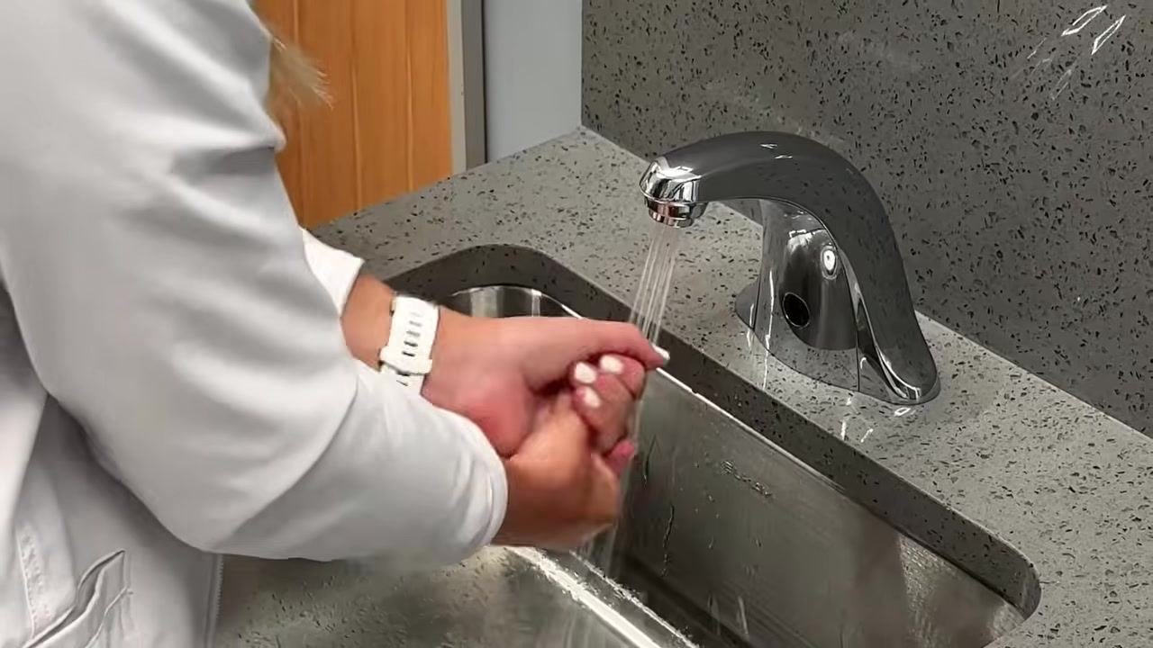 Gloved hands holding a BD Eclipse 3 mL, 25-gauge, 5/8 inch syringe package, with alcohol prep pads and vials visible on a white surface