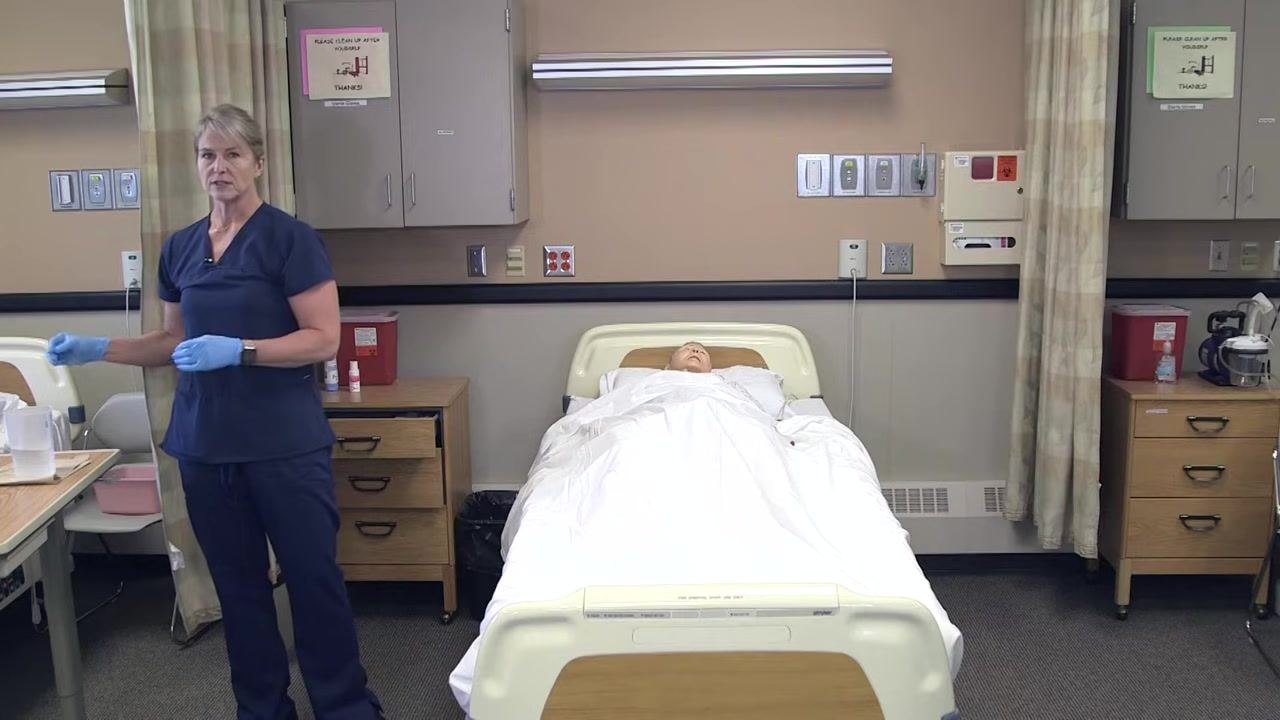 Nursing assistant standing in the room next to the graduated cylinder on the table, demonstrating the final odor assessment