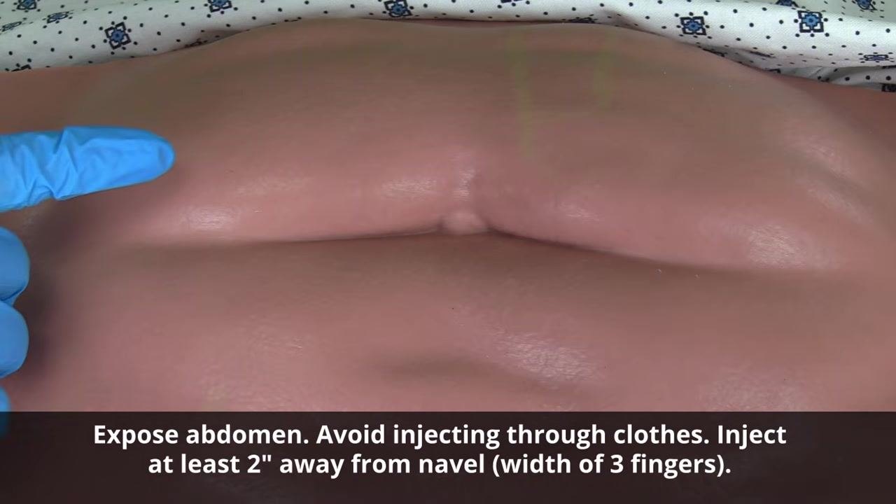 Gloved hand holding a pre-filled enoxaparin syringe horizontally, showing the air bubble that must remain inside before injecting.