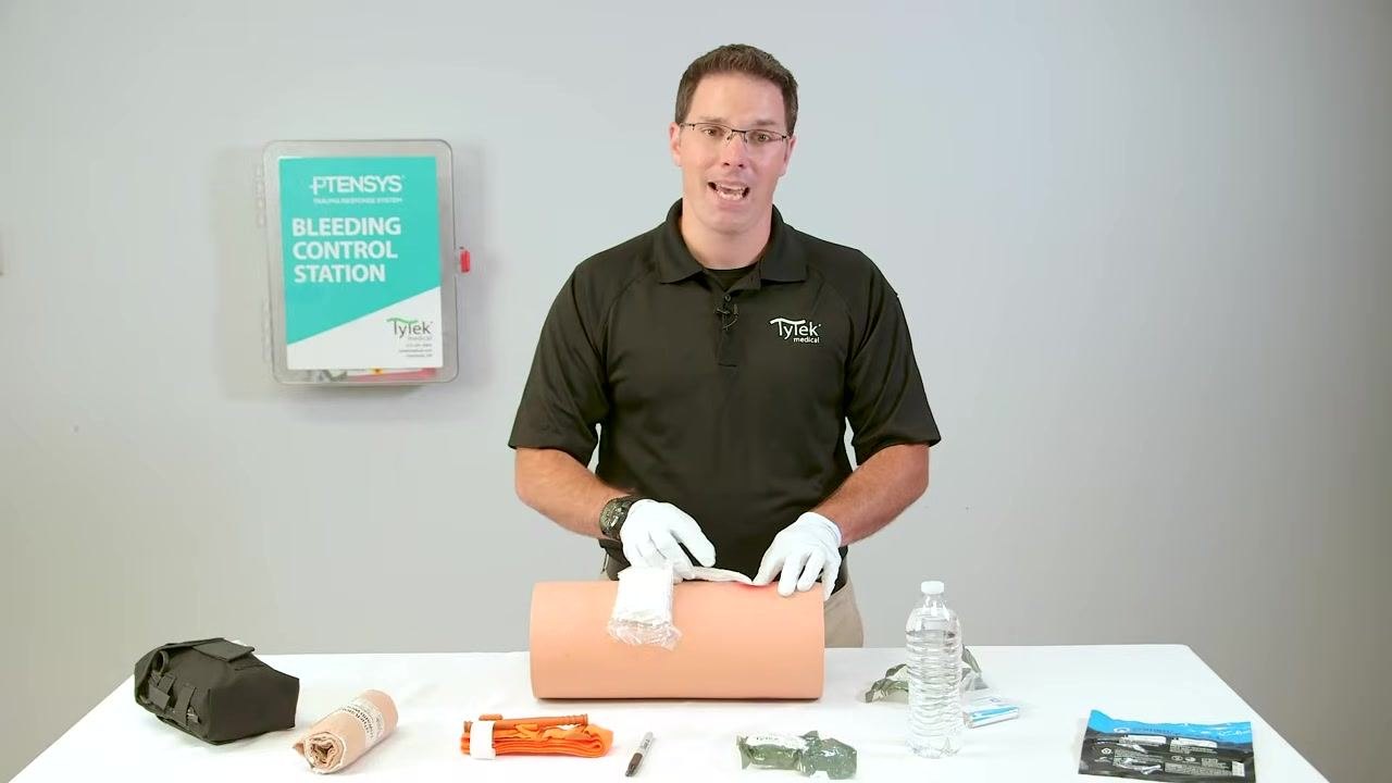 Continuing to emphasize safety precautions during wound packing.