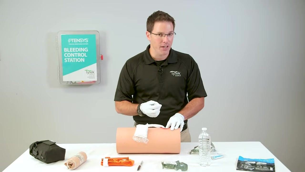 Gesturing to reinforce safety precautions while packing the wound.