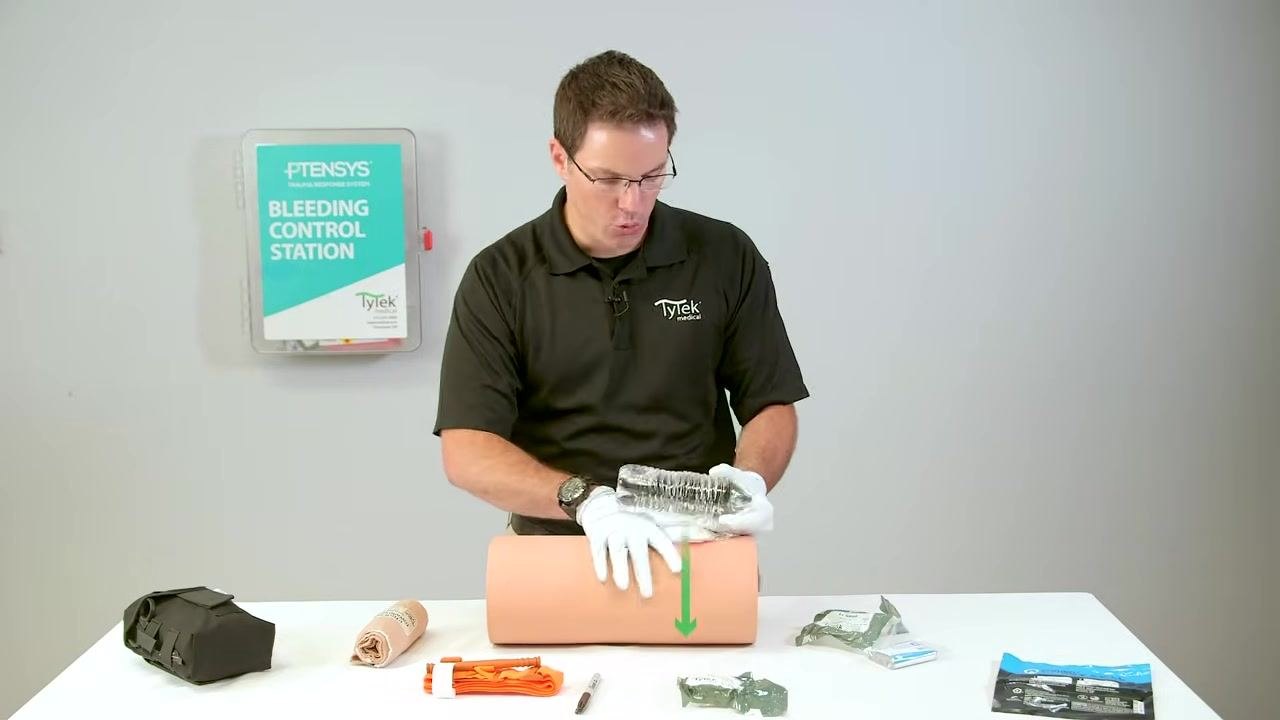 Placing a water bottle on top of the packed wound to act as a bolster.
