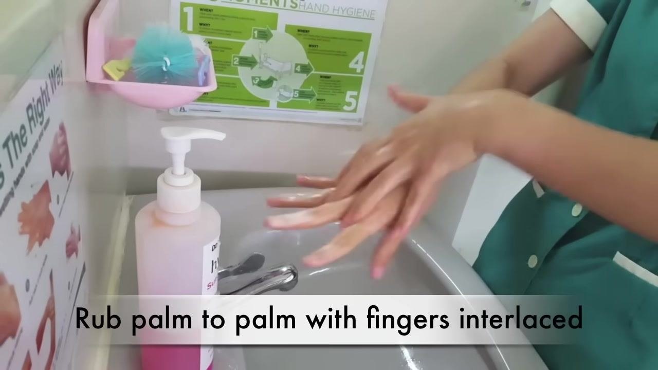 A person dispenses pink liquid soap from a pump bottle into their palm over a sink. The caption reads "with soap and water."