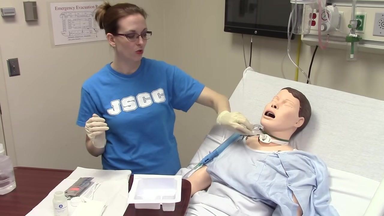 The inner cannula is dropped into the first compartment of the tray, and the oxygen mask is prepared for return to the mannequin.