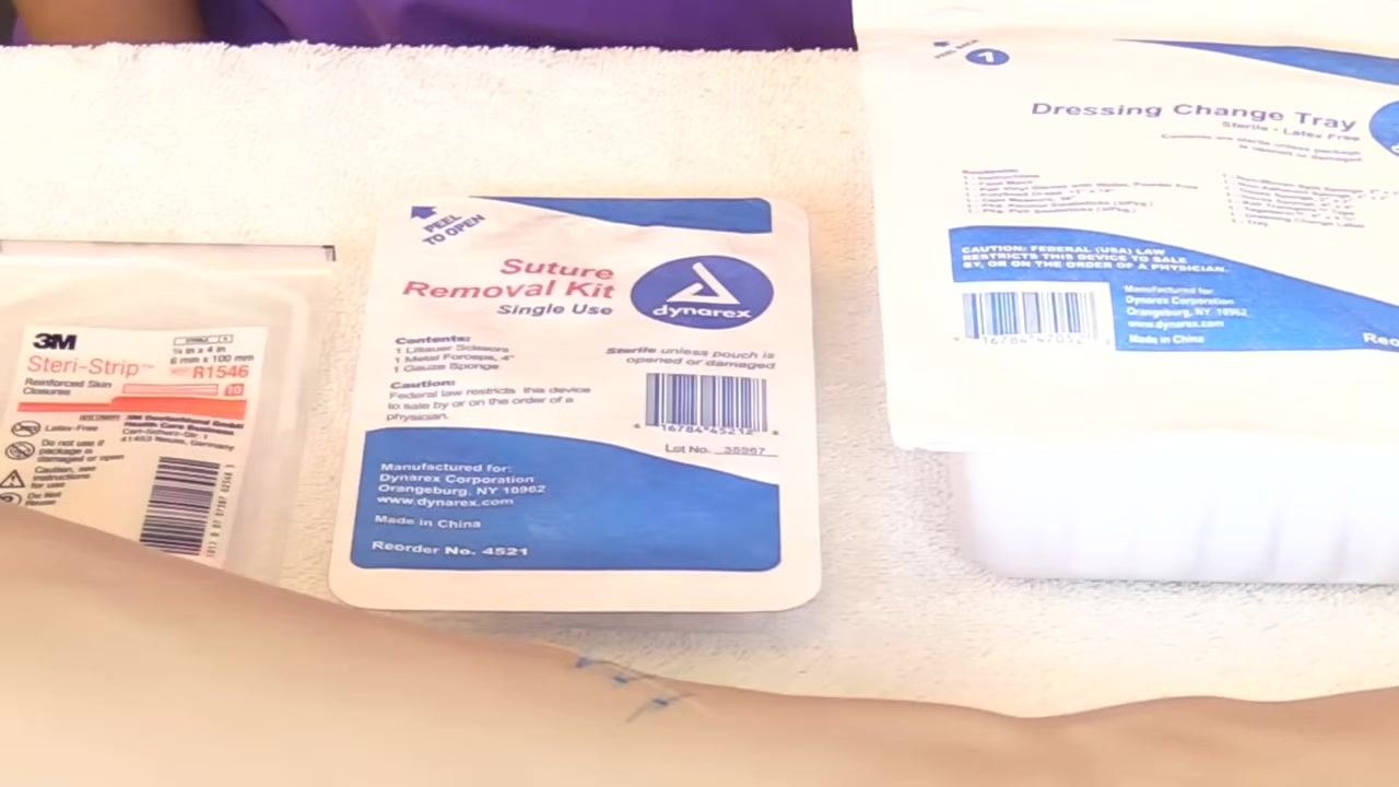 Supplies for suture removal, including reinforced skin closures, a single-use suture removal kit, and a dressing change tray, laid out on a white towel.