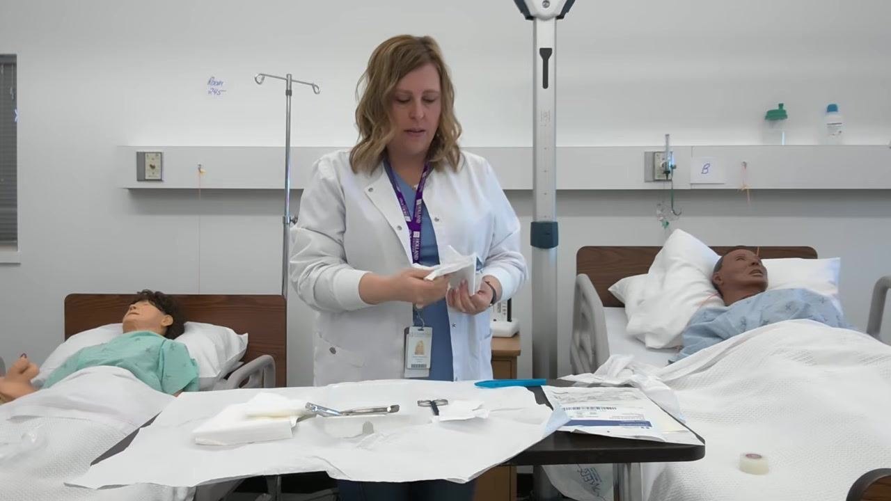 A healthcare professional demonstrates how to use forceps to handle gauze while keeping the tips sterile.