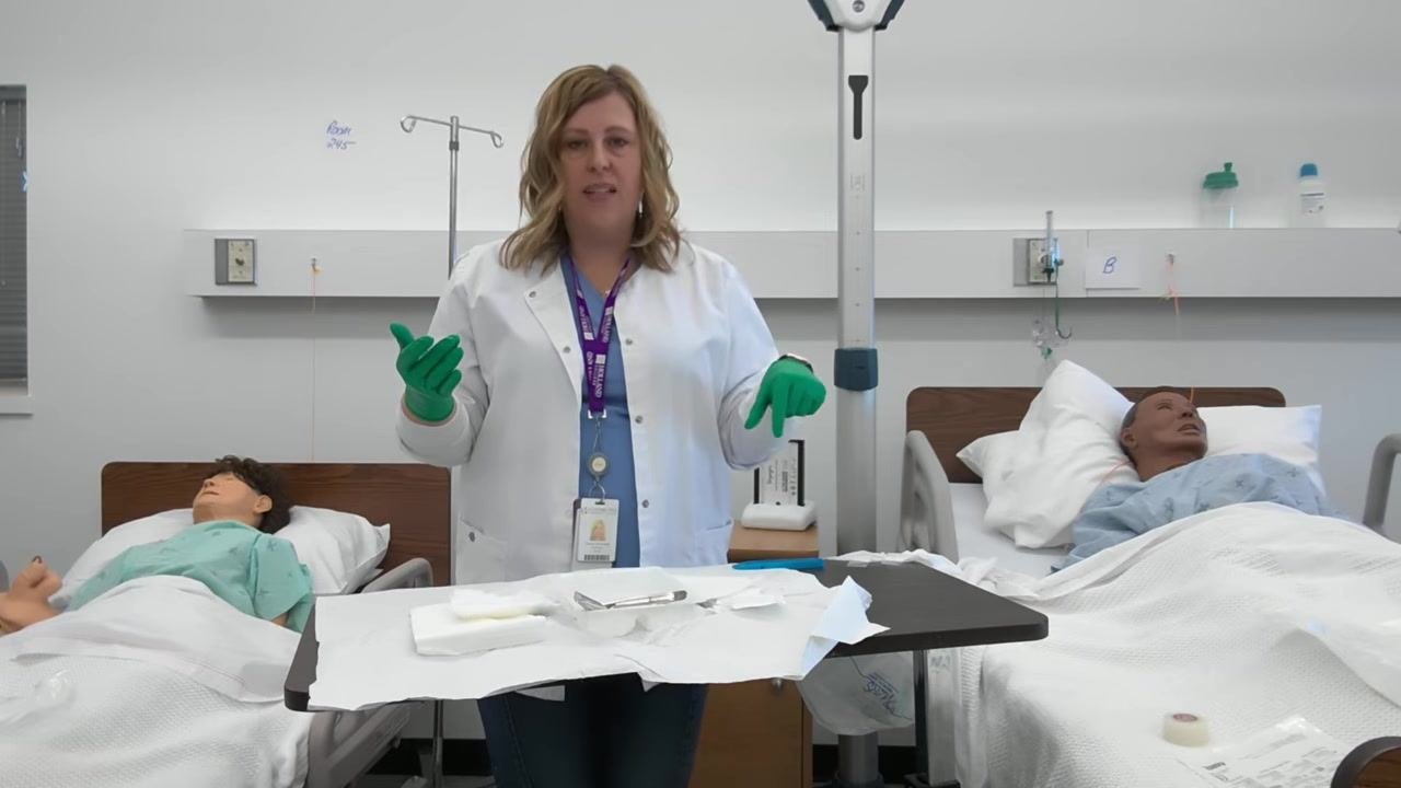 A healthcare professional demonstrates proper hand position, keeping gloved hands above waist level over the sterile tray.