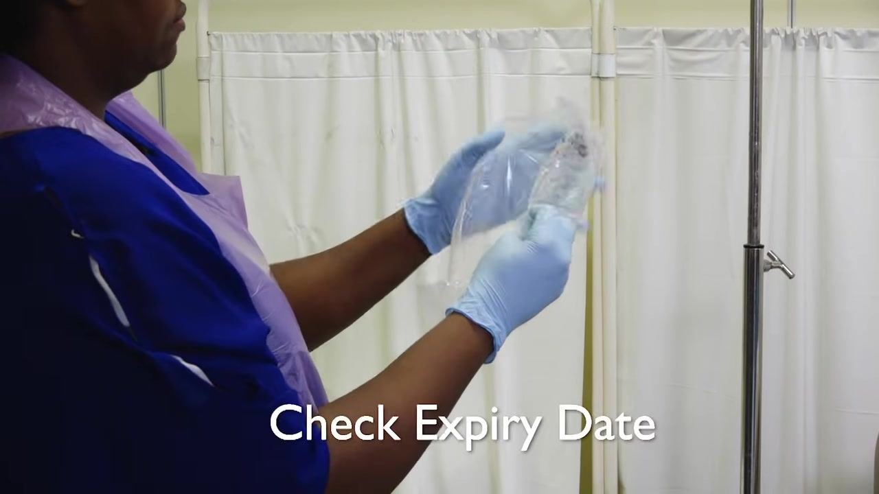 Gloved hands opening a sterile administration set package labeled "Intrafix SafeSet" by B. Braun.