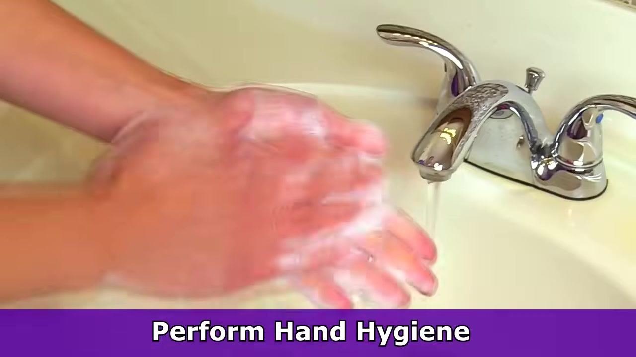 Gloved hands holding a patient's hand with visibly trimmed hair, prepared for IV insertion