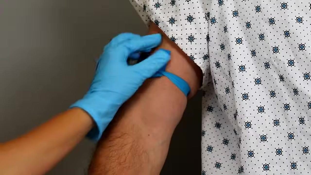 Advancing the catheter slightly further after blood return, with gloved hands maintaining control