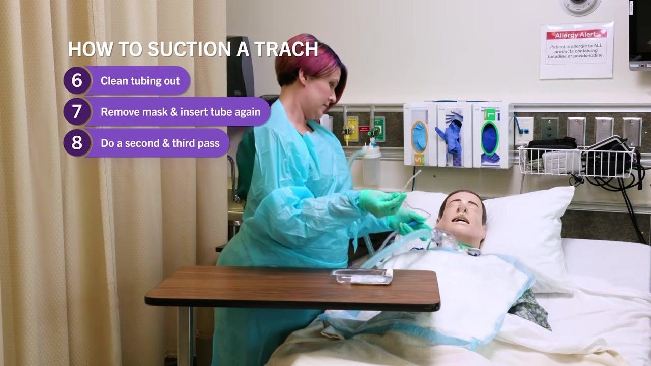 Clinician in PPE performing additional suction passes, on-screen checklist: Do a second & third pass