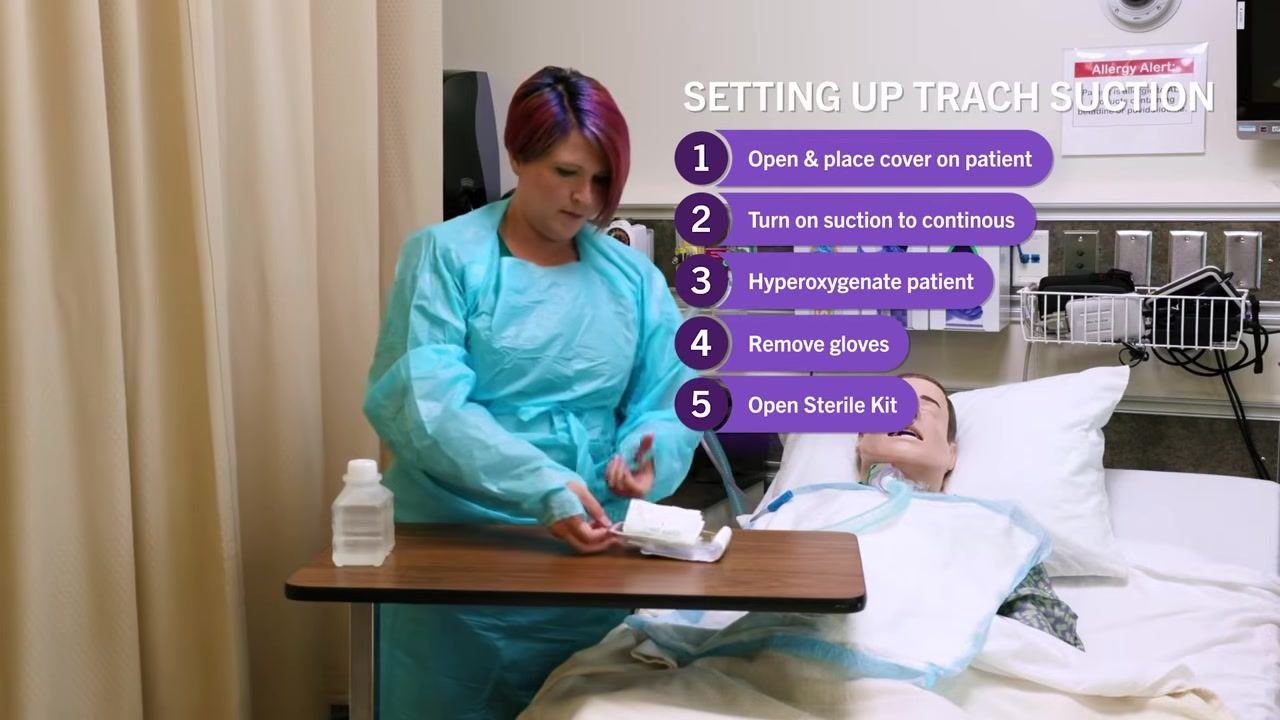 Nurse in blue gown and gloves adjusting the oxygen flow meter on the wall, with suction equipment and oxygen outlets visible. On-screen checklist: "1. Open & place cover on patient, 2. Turn on suction to continuous, 3. Hyperoxygenate patient"
