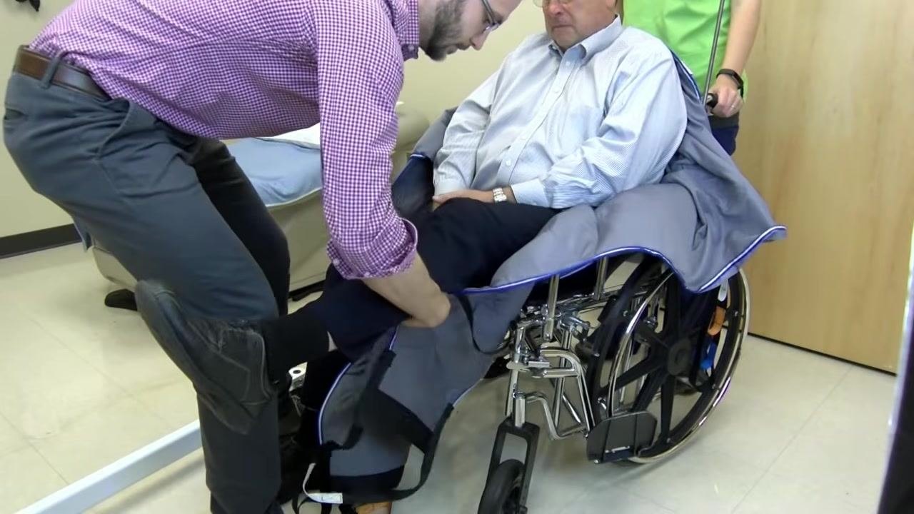 The same process is repeated for the other leg, positioning both edges of the sling under the patient's legs.