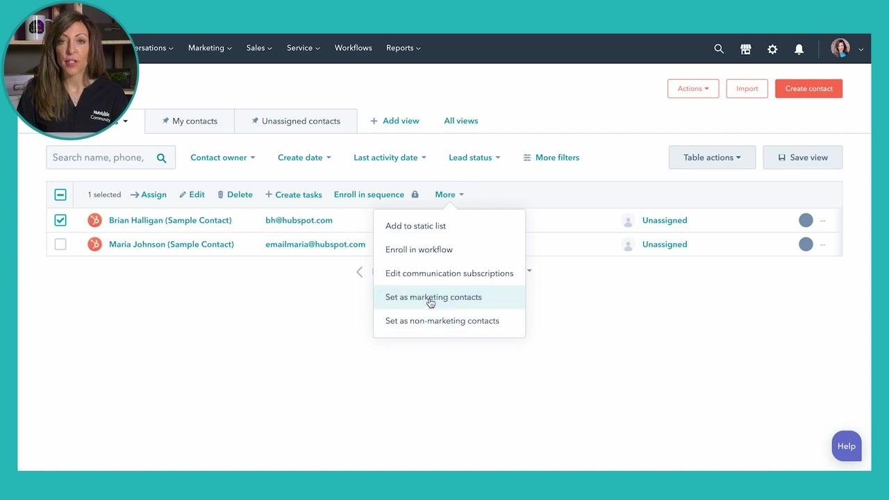HubSpot contact list showing two sample contacts, Brian Halligan and Maria Johnson, with checkboxes next to each name and the cursor hovering over Brian Halligan's checkbox. Filtering and contact management options are visible in the interface.
